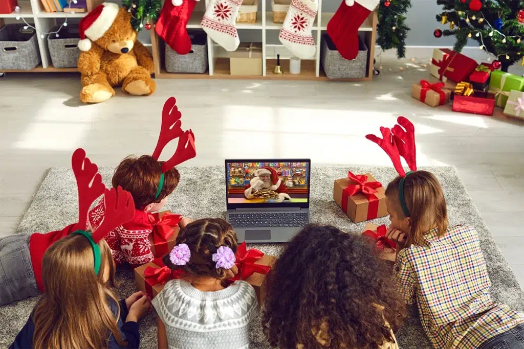 Holiday Prep Guide: How to Prepare for Your Chat with Santa 36 A group of children with red reindeer antlers lie on the floor as they enjoy their Video Call With Santa Claus