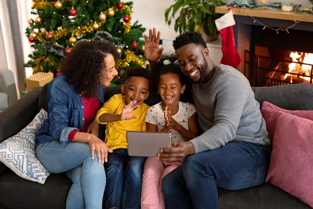 Virtual Santa Visit - Enjoy a Live Video Chat with Santa Claus! 22 A family watching a keepsake video of their virtual Santa visit