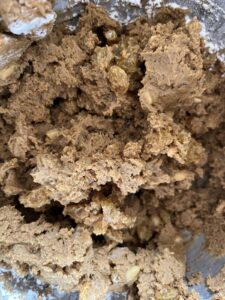 Jamaican black cake cookies, adding the wet ingredients to the dry to form the dough