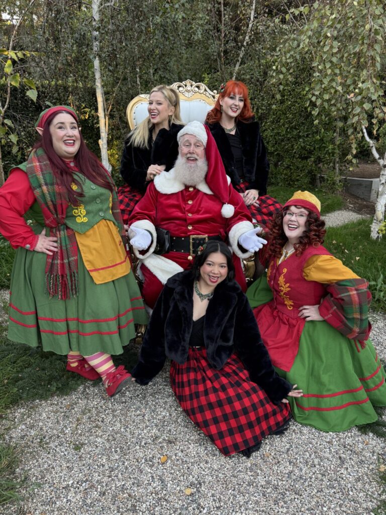 Santa Claus with North Pole Elves during a live home visit in Los Angeles, California