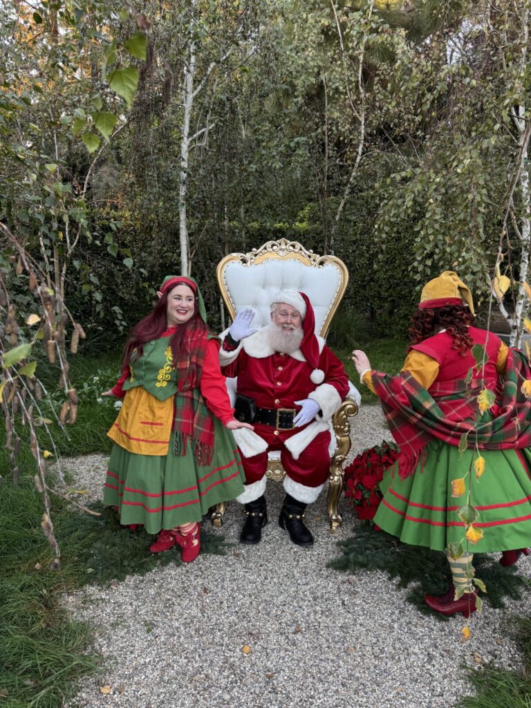 Santa Claus with North Pole Elves during a live home visit in Los Angeles, California
