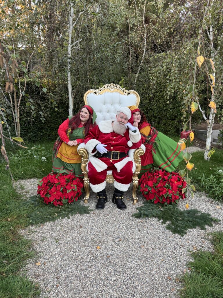 Santa Claus with North Pole Elves during a live home visit in Los Angeles, California