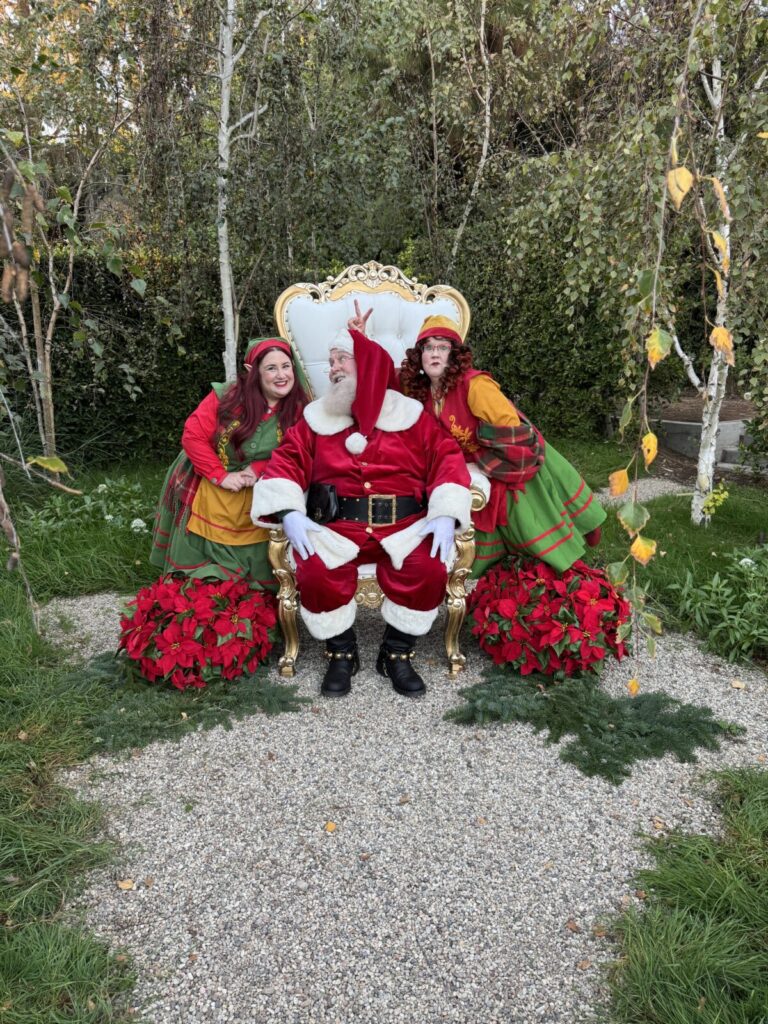 Santa Claus with North Pole Elves during a live home visit in Los Angeles, California